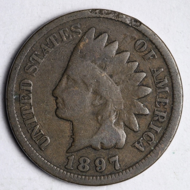 Close-up of the '1 in Neck' misplaced date on the 1897 Indian Head Penny, showing serif protruding from Lady Liberty's neck above the bead necklace